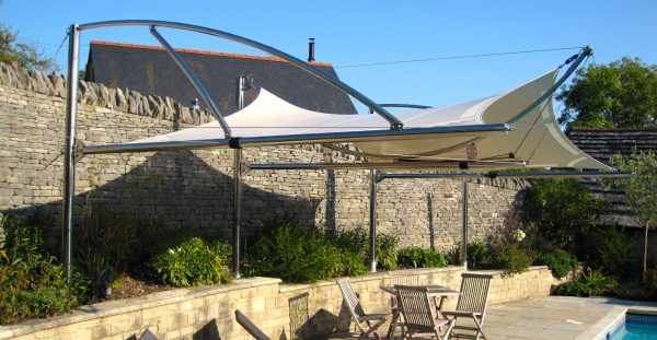 Cantilevered tensile sail over poolside terrace. Bespoke, one off unique structure by Alfresco365